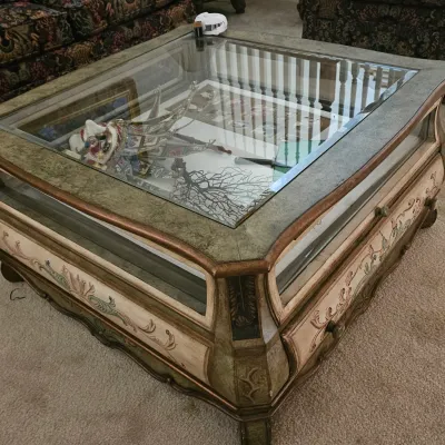 Sale Photo Thumbnail #16: Ornate French Provincial style glass-top display coffee table featuring hand-painted floral motifs and glass side panels.