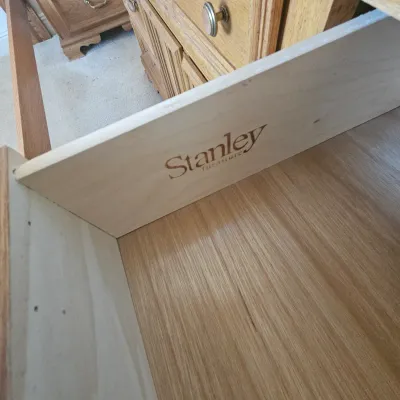 Sale Photo Thumbnail #76: Close-up of an open wooden furniture drawer displaying the Stanley Furniture maker's mark stamped inside.