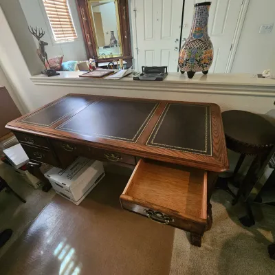 Sale Photo Thumbnail #20: Traditional oak partner's style desk featuring a gold-tooled leather top surface, brass bail handles, and cabriole legs.