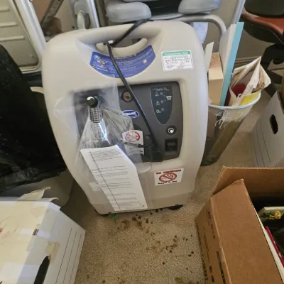 Sale Photo Thumbnail #46: Invacare Perfecto2 V portable oxygen concentrator with power cord and attached instruction packet.