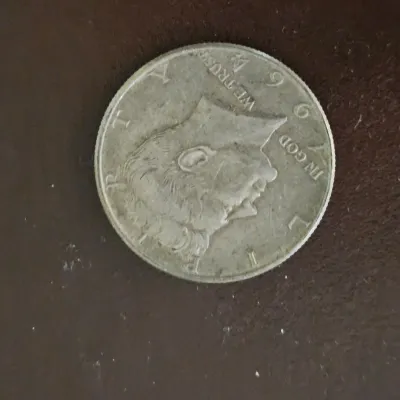 Sale Photo Thumbnail #85: 1964 Kennedy half dollar silver coin, showing light surface wear.