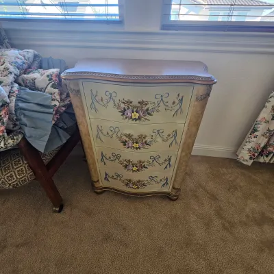Sale Photo Thumbnail #70: French Provincial style hand-painted four-drawer chest featuring floral motifs and gilded ornate brass hardware.