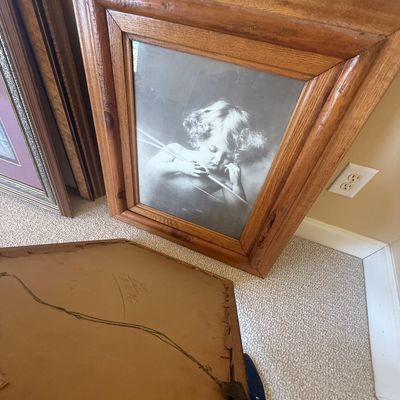 Sale Photo Thumbnail #170: Framed black-and-white print of Cupid, housed in a thick oak wood frame.