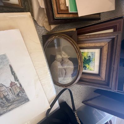 Sale Photo Thumbnail #187: Collection of framed artwork and vintage photographs, including an oval antique mother and baby portrait, various matted prints, and decorative wooden frames.