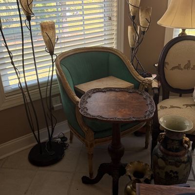 Sale Photo Thumbnail #69: French provincial style green velvet barrel chair paired with a carved wooden tilt-top accent table and multi-light organic floor lamps.