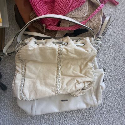 Sale Photo Thumbnail #186: Collection of assorted handbags and purses, including a off-white leather bucket bag with metallic whipstitching and several woven yarn bags.