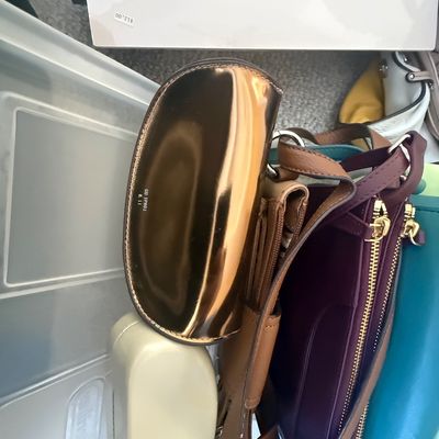 Sale Photo Thumbnail #188: Collection of assorted modern women's handbags and purse cases, including metallic copper, plum leather, and teal options.