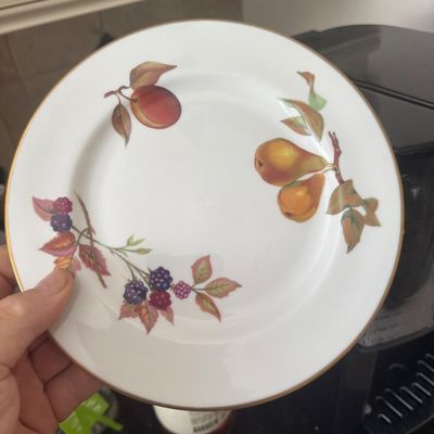 Sale Photo Thumbnail #11: A vintage fine bone china plate featuring a botanical fruit pattern of pears, berries, and a plum with a gilded gold rim.