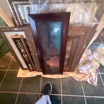 Sale Photo Thumbnail #157: Collection of framed artwork and ornate wall mirrors, including a tall mahogany-framed piece and ornate gilded frames.