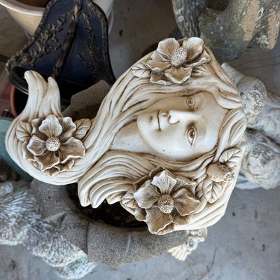Sale Photo Thumbnail #97: Art Nouveau style maiden wall plaque adorned with large flowers, crafted from composite stone or resin with a antique cream finish.