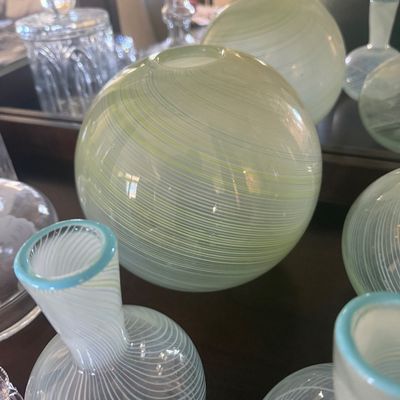 Sale Photo Thumbnail #107: Collection of light green and white swirl hand-blown art glass vases and spherical decorative globes.