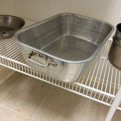 Sale Photo Thumbnail #83: Vintage heavy-duty aluminum roasting pan with riveted side handles, sitting on a white wire shelving unit.
