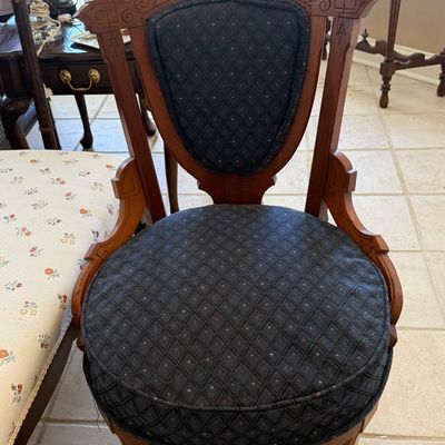 Sale Photo Thumbnail #3: Victorian Eastlake-style carved wooden side chair featuring a ornate crest rail, carved details, and dark blue patterned fabric upholstery.