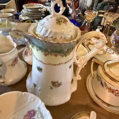 Sale Photo Thumbnail #48: Antique porcelain coffee pot featuring delicate hand-painted floral motifs and gilded accents.