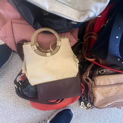 Sale Photo Thumbnail #167: Assortment of modern and vintage women's handbags in various materials, colors, and styles, including leather shoulder bags and tote bags.