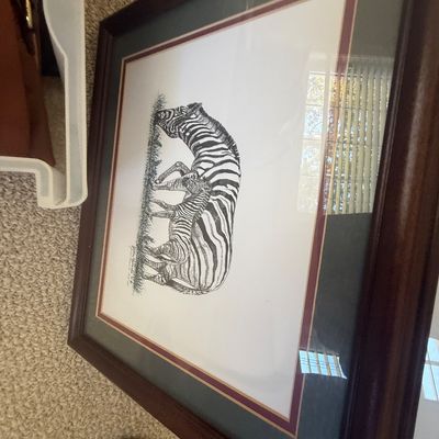 Sale Photo Thumbnail #193: Framed black and white illustration of a zebra and foal, double-matted in dark green and maroon under glass in a dark wooden frame.