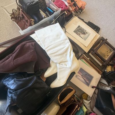 Sale Photo Thumbnail #191: Large collection of women's accessories and decor, featuring vintage white slouch boots, brown wedge boots, assorted leather handbags, and small framed artwork.