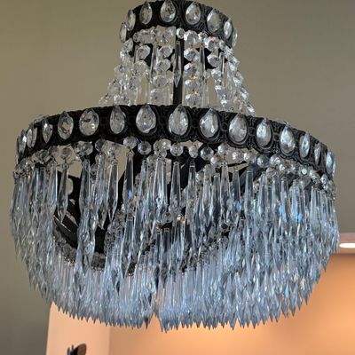Sale Photo Thumbnail #16: Ornate tiered crystal chandelier featuring a dark bronze-toned metal frame set with faceted crystal jewels and cascading prism icicle drops.