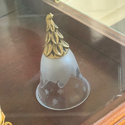 Sale Photo Thumbnail #119: Commemorative 1999 frosted glass bell featuring star etchings and a brass Christmas tree handle.