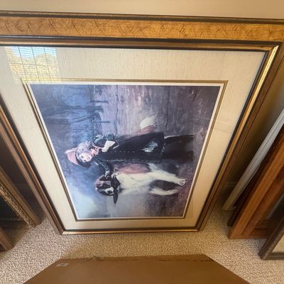 Sale Photo Thumbnail #173: Large framed art print depicting a child in historical attire with a dog, set in a double-matted gilt frame.
