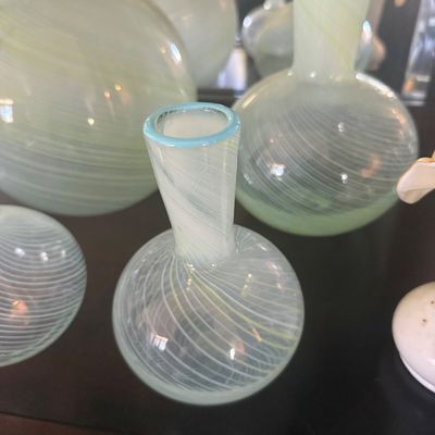 Sale Photo Thumbnail #5: Collection of blown art glass vases featuring white swirl filigree patterns and pale green accents.