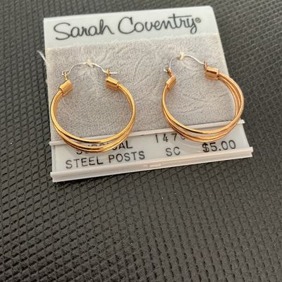 Sale Photo Thumbnail #180: Pair of vintage Sarah Coventry gold-tone multi-strand/triple hoop pierced earrings. Features surgical steel posts. Still attached to original Sarah Coventry display card. In good vintage condition with minimal wear.
