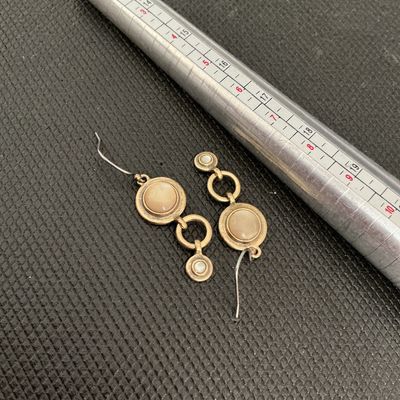 Sale Photo Thumbnail #194: Pair of vintage-style bronze tone dangle/drop earrings featuring round inlaid mother-of-pearl or neutral tone cabochons connected by open circle links. Shepherd hook ear wires. Good pre-owned condition with light surface wear.