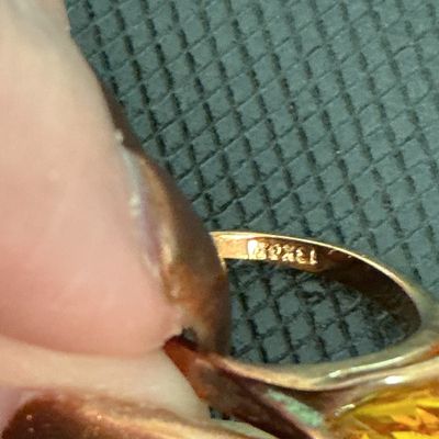 Sale Photo Thumbnail #156: Vintage gold ring featuring a distinctive triangular-cut faceted yellow stone (possibly citrine or topaz tone). The band is stamped inside with '10K' (or similar gold hallmark). Measures approximately US size 6 on a ring mandrel. Good condition with light