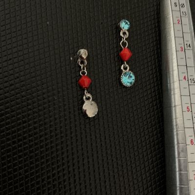 Sale Photo Thumbnail #148: Pair of costume dangle earrings featuring light blue round rhinestones and red bicone-style beads on silver-tone chain links. Note: One earring is missing its lower blue stone setting backing as shown in photos. Measures approximately 1.25 inches in total