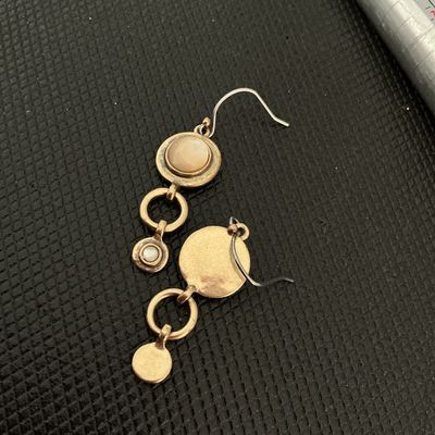 Sale Photo Thumbnail #195: Pair of vintage-style bronze tone dangle/drop earrings featuring round inlaid mother-of-pearl or neutral tone cabochons connected by open circle links. Shepherd hook ear wires. Good pre-owned condition with light surface wear.