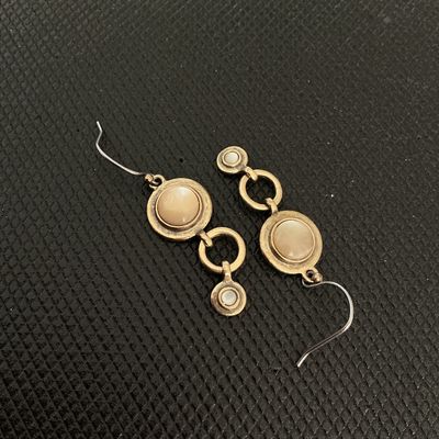 Sale Photo Thumbnail #193: Pair of vintage-style bronze tone dangle/drop earrings featuring round inlaid mother-of-pearl or neutral tone cabochons connected by open circle links. Shepherd hook ear wires. Good pre-owned condition with light surface wear.