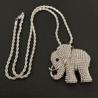 Sale Photo Thumbnail #170: Silver-tone rope chain necklace featuring a detailed elephant pendant encrusted with faux mini pearls and a dark rhinestone eye. Includes a lobster claw clasp closure. Good condition with no missing stones visible.