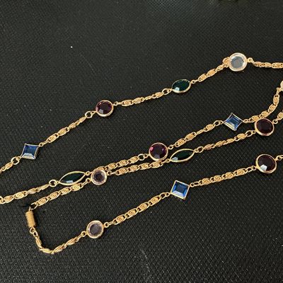 Sale Photo Thumbnail #166: A vintage-style long gold-tone chain necklace featuring bezel-set multi-colored glass jewels in various shapes including round, square/diamond, marquise, and oval. Colors include deep red/purple, blue, green, and clear/lavender. Good overall condition wit