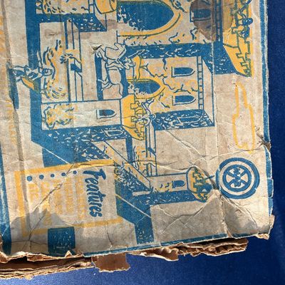 Sale Photo Thumbnail #16: Vintage Marx medieval castle playset box showing blue and yellow printed graphics, featuring heavy wear, creasing, and edge damage.