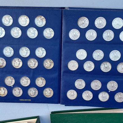 Sale Photo Thumbnail #75: Blue Whitman-style coin collector album filled with US Washington silver quarters.