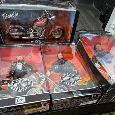Sale Photo Thumbnail #48: Collection of four Harley-Davidson Barbie Collectibles in original boxes, including three biker dolls and a red motorcycle, from the late 1990s.