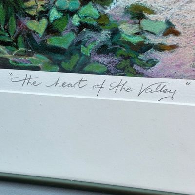 Sale Photo Thumbnail #81: Close-up of a framed art print titled "The Heart of the Valley" in pencil along the bottom margin.