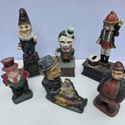 Sale Photo Thumbnail #53: Collection of six antique painted cast iron mechanical and still banks featuring whimsical character figures with visible paint wear.