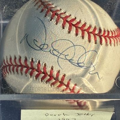 Sale Photo Thumbnail #28: Autographed Derek Jeter baseball in a clear protective display cube, accompanied by a handwritten note attributing it to 1997 with the New York Yankees.