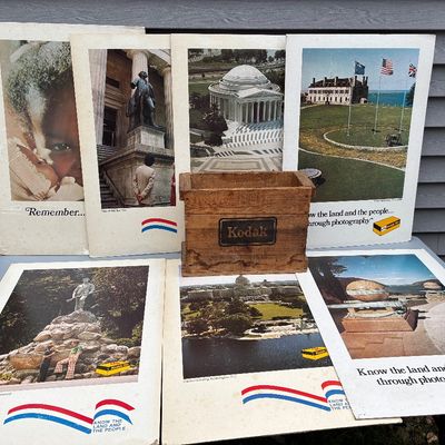 Sale Photo Thumbnail #106: Vintage Kodak wooden film crate surrounded by vintage promotional Kodak posters depicting American landmarks.