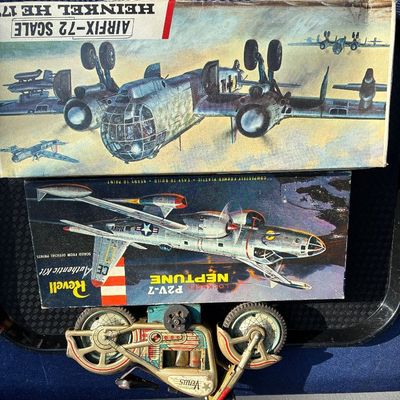 Sale Photo Thumbnail #11: Vintage tin litho friction motorcycle toy alongside vintage boxed Revell Lockheed P2V-7 Neptune and Airfix Heinkel He 177 model airplane kits.