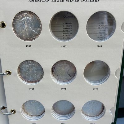 Sale Photo Thumbnail #73: American Eagle Silver Dollars album containing multiple coins from 1986 through the 1990s.