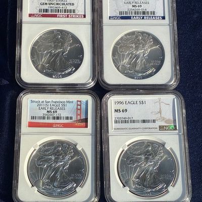 Sale Photo Thumbnail #30: Four NGC-certified American Silver Eagle $1 coins, including dates 1996, 2006, 2009, and 2011(S), graded MS 69 and Gem Uncirculated.