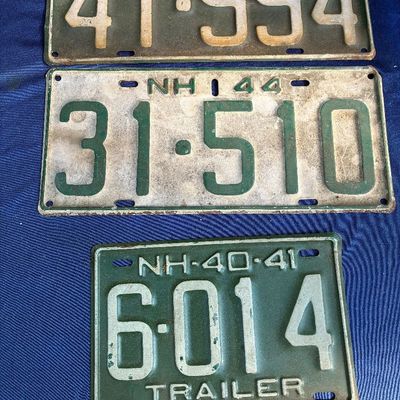 Sale Photo Thumbnail #20: Trio of vintage New Hampshire license plates from the 1940s, showing authentic wear, patina, and surface weathering.