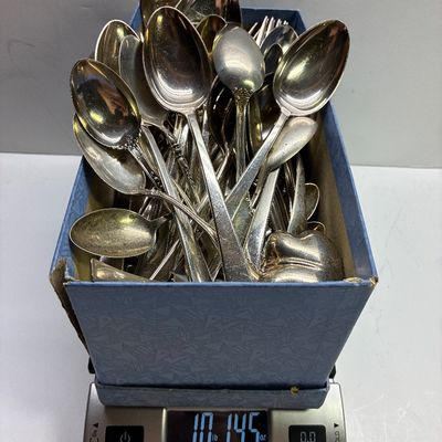 Sale Photo Thumbnail #44: Box lot of assorted silverplate and metal flatware, including various spoons and forks, shown on a digital scale weighing 10 pounds 14.5 ounces.