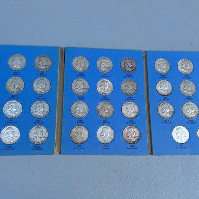 Sale Photo Thumbnail #72: Three Whitman blue coin folder albums filled with silver Benjamin Franklin half dollars spanning from 1948 to 1963.