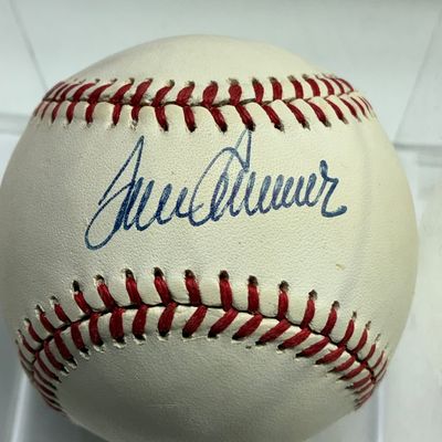 Sale Photo Thumbnail #103: Autographed baseball featuring a clear signature in blue ink on the sweet spot, housed in a plastic display case.
