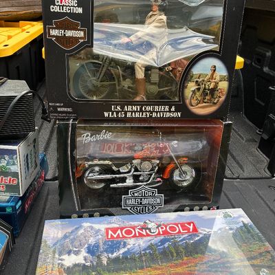 Sale Photo Thumbnail #49: Collection of collectible toys in boxes, including a G.I. Joe Classic Collection U.S. Army Courier with Harley-Davidson set, a Barbie Harley-Davidson motorcycle, and a National Parks edition Monopoly board game.