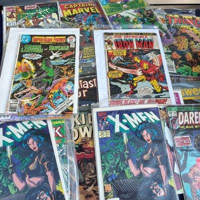 Sale Photo Thumbnail #25: Collection of vintage Marvel and DC comic books, including issues of Uncanny X-Men, Iron Man, and Daredevil, individually bagged and boarded for protection.