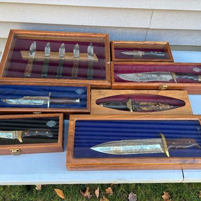 Sale Photo Thumbnail #111: Collection of decorative hunting and Bowie knives in custom wooden display cases.